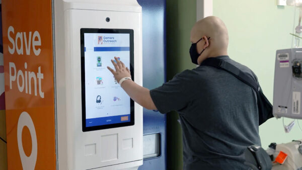 Kid selecting a prize from a Save Point machine.